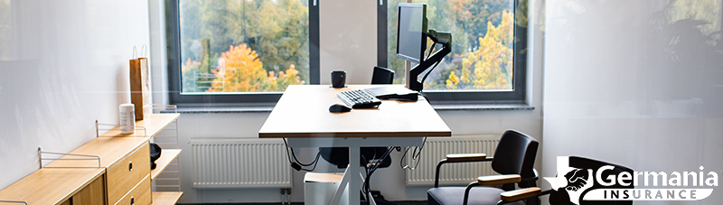 A standing desk surrounded by chairs